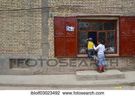 Uighur Muslim Children In Front Of A Basic Store Kashgar