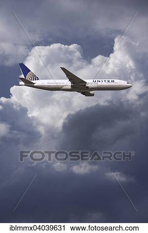 United Airlines Boeing 777 in flight in bad weather View Large Photo Image Stock Image - United Airlines Boeing 777 in flight in bad weather. Fotosearch