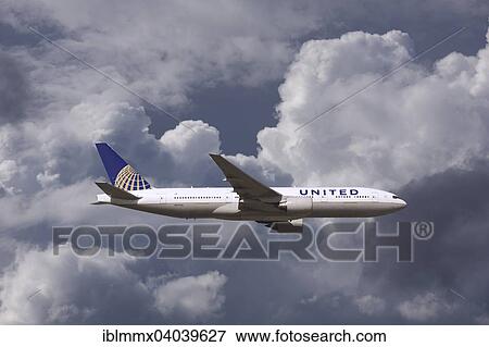 Stock Photo - United Airlines Boeing 777 in flight in bad weather. Fotosearch