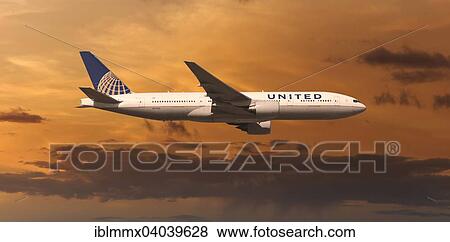United Airlines Boeing 777 in flight in the evening light View Large Photo Image Stock Photo - United Airlines Boeing 777 in flight in the evening light. Fotosearch