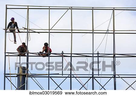 "Unsecured workers assembling a scaffold, Banjar Kertabuana, Denpasar, Bali, Indonesia, Asia" View Large Photo Image Stock Photo - "Unsecured workers assembling a scaffold, Banjar Kertabuana, Denpasar, Bali, Indonesia, Asia". Fotosearch