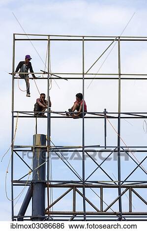 "Unsecured workers assembling scaffolding, Banjar Kertabuana, Denpasar, Bali, Indonesia, Asia" View Large Photo Image Stock Photograph - "Unsecured workers assembling scaffolding, Banjar Kertabuana, Denpasar, Bali, Indonesia, Asia". Fotosearch