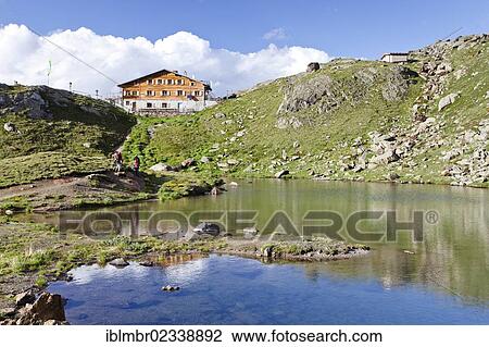 Stock Image - "Untere Kozenlacke lake looking towards the Marteller Huette hut, during the descent from Zufallferner Glacier to Marteller Huette hut in the Martell Valley, Alto Adige, Italy, Europe". Fotosearch