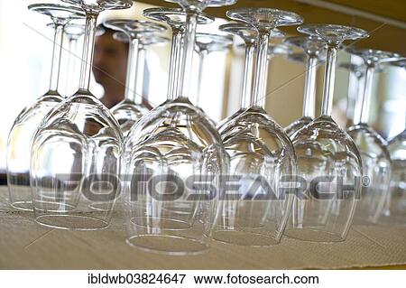 Upside down wine glasses in a restaurant View Large Photo Image Stock Photo - Upside down wine glasses in a restaurant. Fotosearch
