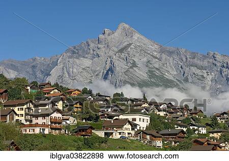 Stock Photo - "Valaisian village of Sornard in front of the summit of Haut de Cry Mountain, Valais, Switzerland, Europe". Fotosearch
