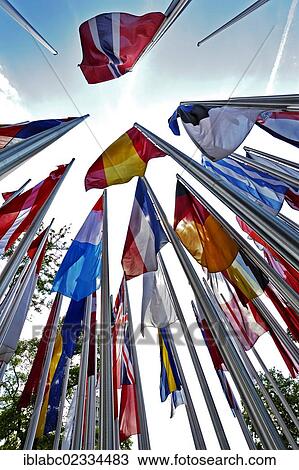 Stock Image - "Various international flags on poles in the wind, Munich, Bavaria, Germany, Europe". Fotosearch
