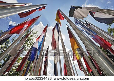 "Various international flags on poles in the wind, Munich, Bavaria, Germany, Europe" View Large Photo Image Stock Photograph - "Various international flags on poles in the wind, Munich, Bavaria, Germany, Europe". Fotosearch