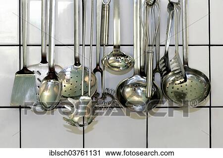 "Various kitchen ladles hanging in front of a white tiled wall, Germany, Europe" View Large Photo Image Stock Image - "Various kitchen ladles hanging in front of a white tiled wall, Germany, Europe". Fotosearch