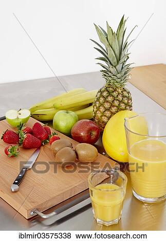 "Various types of fruit on a cutting board, orange juice to one side, Germany, Europe" View Large Photo Image Stock Photo - "Various types of fruit on a cutting board, orange juice to one side, Germany, Europe". Fotosearch