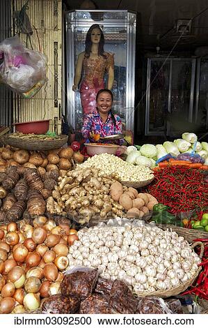 Stock Image - "Vegetable seller at a market, Siem Reap, Siem Reap, Siem Reap Province, Cambodia, Asia". Fotosearch