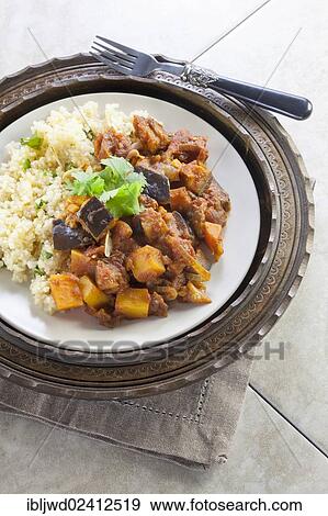 Stock Photo - Vegetable tagine with lemon and coriander cous cous. Fotosearch