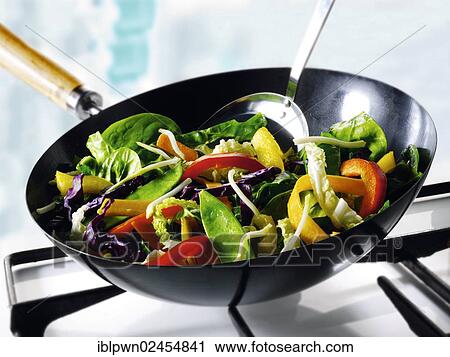 Vegetables being stirfried in a wok View Large Photo Image Stock Image - Vegetables being stirfried in a wok. Fotosearch