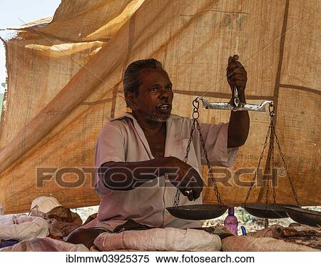 Stock Photography - "Vendor holding scales, Indian market, Chinnamanur, Tamil Nadu, India, Asia". Fotosearch