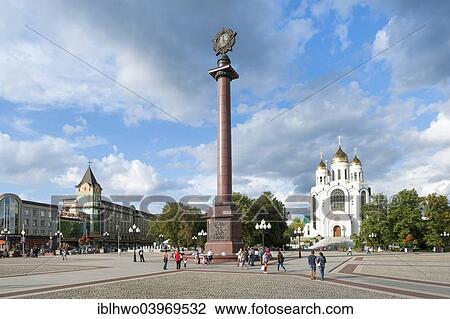Stock Image - "Victory Column with a stylized medal, World War II, Victory Square, Russian Orthodox Cathedral at the back, Centralnij rajon, Kaliningrad, Kaliningrad Oblast, Russia, Europe". Fotosearch