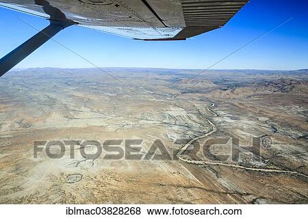 "View from a small plane over the dry riverbed of Oanob River, Khomas Hochland, Namibia, Africa" View Large Photo Image Stock Photo - "View from a small plane over the dry riverbed of Oanob River, Khomas Hochland, Namibia, Africa". Fotosearch
