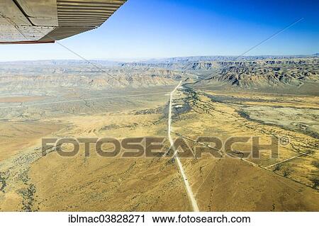 "View from a small plane over the sand road C26, disappearing between the mountains in the direction of Gamsberg Pass, Khomas Hochland, Namibia, Africa" View Large Photo Image Stock Image - "View from a small plane over the sand road C26, disappearing between the mountains in the direction of Gamsberg Pass, Khomas Hochland, Namibia, Africa". Fotosearch