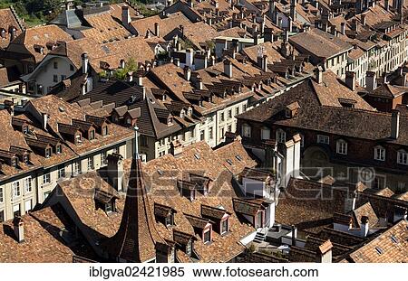 Stock Photography - View from above over the red-tiled roofs of the houses in the historic town center of Bern, Switzerland, Europe. Fotosearch