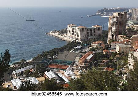 "View from above over the tennis courts of the Monte Carlo Country Club, Monte Carlo Bay Hotel & Resort and the skyscrapers of Monte Carlo, Principality of Monaco, Cote d'Azur, Mediterranean Sea, Europe" View Large Photo Image Stock Photography - "View from above over the tennis courts of the Monte Carlo Country Club, Monte Carlo Bay Hotel & Resort and the skyscrapers of Monte Carlo, Principality of Monaco, Cote d'Azur, Mediterranean Sea, Europe". Fotosearch