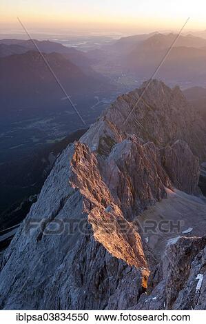 "View from Mt Zugspitze of the Waxenstein Range and Hollental Valley, in the first morning light at sunrise, Bavaria, Germany, Europe" View Large Photo Image Stock Image - "View from Mt Zugspitze of the Waxenstein Range and Hollental Valley, in the first morning light at sunrise, Bavaria, Germany, Europe". Fotosearch