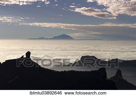 Stock Photograph - "View from Pico de las Nieves in Gran Canaria across Roque Nublo to Mount Teide in Tenerife, La Culata, Risco Blanco, Canary Islands, Spain, Europe". Fotosearch