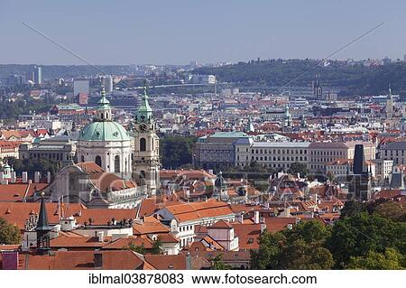 Stock Image - "View from Prague Castle across Mala Strana, Lesser Town of Prague, with St. Nicholas Church and the Mala Strana Bridge Tower, Prague, Bohemia, Czech Republic, Europe". Fotosearch
