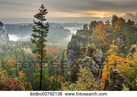 Stock Photo - "View from the Bastei in fall at dawn, Saxon Switzerland National Park, Saxony, Germany, Europe". Fotosearch