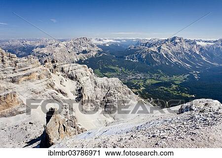 Stock Image - "View from the peak of Mt Tofana di Rozes, Monte Cristallo at back, the village of Cortina d'Ampezzo in the valley below, Ampezzo Dolomites, Belluno, Italy, Europe". Fotosearch