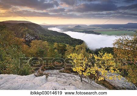 "View from the Schrammsteine rocks over the Elbe Valley towards Zirkelstein and Kaiserkrone in autumn at sunrise, Elbe Sandstone Mountains, Saxon Switzerland region, Saxony, Germany, Europe" View Large Photo Image Stock Photo - "View from the Schrammsteine rocks over the Elbe Valley towards Zirkelstein and Kaiserkrone in autumn at sunrise, Elbe Sandstone Mountains, Saxon Switzerland region, Saxony, Germany, Europe". Fotosearch