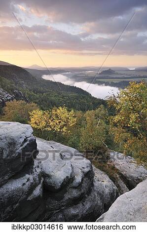"View from the Schrammsteine rocks over the Elbe Valley towards Zirkelstein and Kaiserkrone in autumn at sunrise, Elbe Sandstone Mountains, Saxon Switzerland region, Saxony, Germany, Europe" View Large Photo Image Stock Photograph - "View from the Schrammsteine rocks over the Elbe Valley towards Zirkelstein and Kaiserkrone in autumn at sunrise, Elbe Sandstone Mountains, Saxon Switzerland region, Saxony, Germany, Europe". Fotosearch