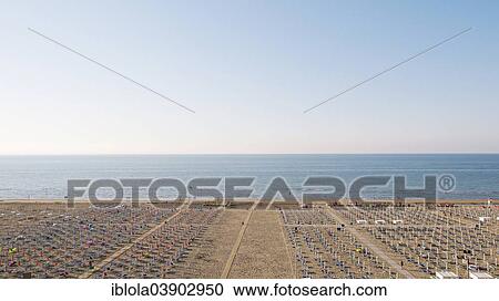 Stock Image - "View of a beach with sunshades and sun beds at sunrise, 8 am, image 4 of 9, Lignano Sabbiadoro, Udine province, Adriatic Coast, Italy, Europe". Fotosearch