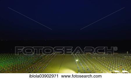 Stock Image - "View of a beach with sunshades and sun beds at midnight, image 9 of 9, Lignano Sabbiadoro, Udine province, Adriatic Coast, Italy, Europe". Fotosearch