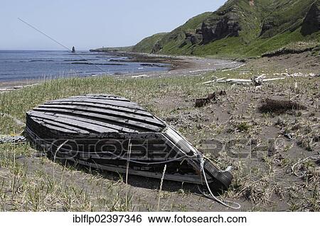Stock Photograph - "View of boat and coastline, Urup Island, Kuril Islands, Sea of Okhotsk, Sakhalin Oblast, Russian Far East, Russia, Europe". Fotosearch