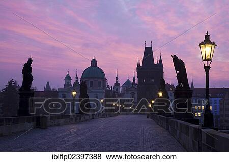 Stock Photo - "View of bridge in city at dawn, Charles Bridge, Vltava River, Prague, Czech Republic, Europe". Fotosearch