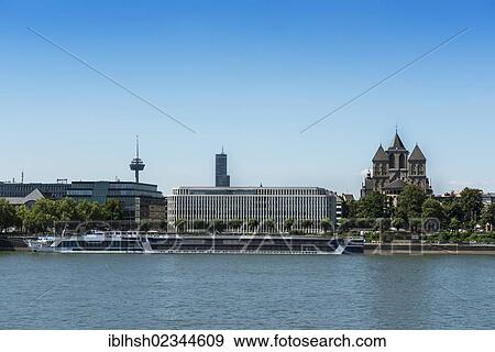 "View of Cologne as seen from Deutz across the Rhine river, Colonius tower, Koeln-Turm tower, the Konrad-Adenauer-Ufer promenade with administrative buildings and the Church of St. Kunibert, North Rhine-Westphalia, Germany, Europe" View Large Photo Image Stock Photo - "View of Cologne as seen from Deutz across the Rhine river, Colonius tower, Koeln-Turm tower, the Konrad-Adenauer-Ufer promenade with administrative buildings and the Church of St. Kunibert, North Rhine-Westphalia, Germany, Europe". Fotosearch