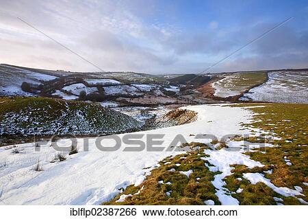 "View of lingering snow on moorland hills and fields, above Sherdon Hutch and Two Moors Way, near Landacre, Exmoor, Somerset, England, United Kingdom, Europe" View Large Photo Image Stock Photograph - "View of lingering snow on moorland hills and fields, above Sherdon Hutch and Two Moors Way, near Landacre, Exmoor, Somerset, England, United Kingdom, Europe". Fotosearch