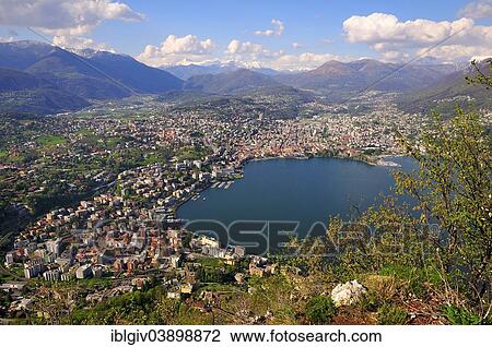 Stock Image - "View of Lugano on Lake Lugano and the Alps, Monte San Salvatore mountain, Lugano, Canton of Ticino, Switzerland, Europe". Fotosearch