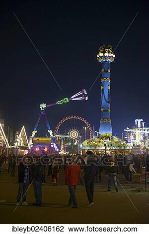 Stock Image - "View of the Cannstatter Volksfest fair, rides, funfair, beer tents, people with the Fruit column, Stuttgart, Baden-Wuerttemberg, Germany, Europe". Fotosearch