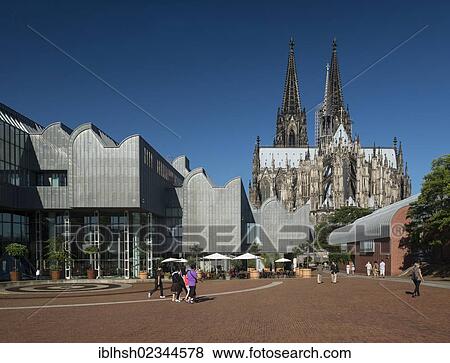 "View of the Ludwig Museum and Cologne Cathedral as seen from Heinrich-Boell-Platz square, tourists walking in the foreground, Cologne, North Rhine-Westphalia, Germany, Europe" View Large Photo Image Stock Photo - "View of the Ludwig Museum and Cologne Cathedral as seen from Heinrich-Boell-Platz square, tourists walking in the foreground, Cologne, North Rhine-Westphalia, Germany, Europe". Fotosearch