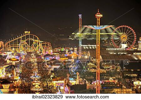 "View of the Oktoberfest festival at night, with illuminated stalls, beer tents and funfair rides, Oktoberfest festival, Munich, Upper Bavaria, Bavaria, Germany, Europe" View Large Photo Image Stock Photo - "View of the Oktoberfest festival at night, with illuminated stalls, beer tents and funfair rides, Oktoberfest festival, Munich, Upper Bavaria, Bavaria, Germany, Europe". Fotosearch
