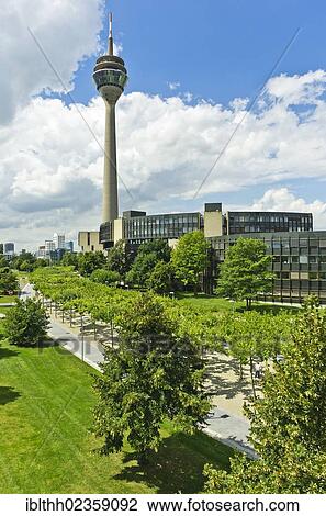 Stock Image - "View of the parliament building and the Rheinturm tower, the WDR building and the Gehry buildings at the back, Medienhafen district, Duesseldorf, North Rhine-Westphalia, Germany, Europe". Fotosearch