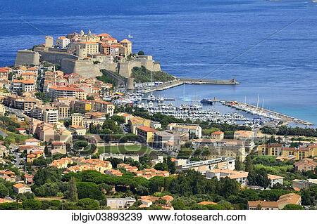 Stock Photo - "View of the town with the harbor and the citadel, Calvi, Corsica, France, Europe". Fotosearch
