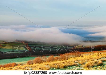 "View of valley with early morning sunshine and heavy fog, over Liddicombe and Moor Gate, Exmoor, North Devon, England, United Kingdom, Europe" View Large Photo Image Stock Image - "View of valley with early morning sunshine and heavy fog, over Liddicombe and Moor Gate, Exmoor, North Devon, England, United Kingdom, Europe". Fotosearch