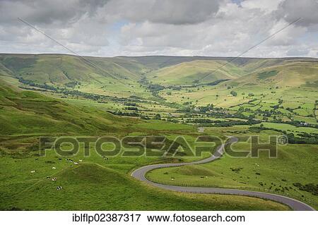 Stock Photo - "View of winding road through pasture with cattle, Vale of Edale, Edale, High Peak District, Derbyshire, England, United Kingdom, Europe". Fotosearch