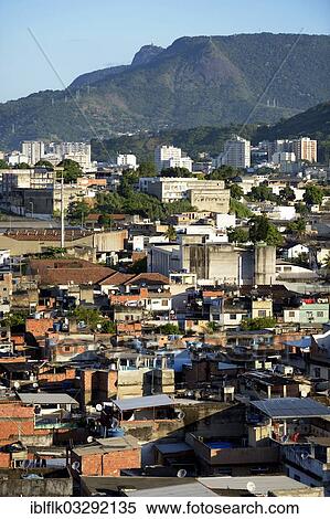 "View over a slum or favela towards the high-rise apartment buildings where the urban middle class live, Corcovado Mountain at the rear, Jacarezinho favela, Rio de Janeiro, Rio de Janeiro State, Brazil, South America" View Large Photo Image Stock Photography - "View over a slum or favela towards the high-rise apartment buildings where the urban middle class live, Corcovado Mountain at the rear, Jacarezinho favela, Rio de Janeiro, Rio de Janeiro State, Brazil, South America". Fotosearch