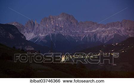 "View over a town towards the mountain range of the Dolomites at night, Bolzano, South Tyrol province, Trentino-Alto Adige, Italy, Europe" View Large Photo Image Stock Photograph - "View over a town towards the mountain range of the Dolomites at night, Bolzano, South Tyrol province, Trentino-Alto Adige, Italy, Europe". Fotosearch
