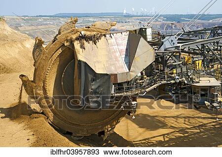 "View over the bucket wheel of an excavator onto a coal power plant, Grevenbroich, North Rhine-Westphalia, Germany, Europe" View Large Photo Image Stock Image - "View over the bucket wheel of an excavator onto a coal power plant, Grevenbroich, North Rhine-Westphalia, Germany, Europe". Fotosearch