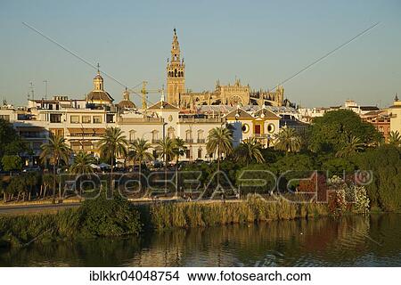 Picture - "View over the Guadalquivir to the bullring and the cathedral, Seville, Andalucia, Spain, Europe". Fotosearch