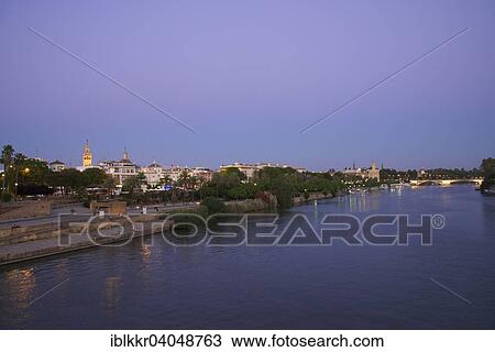 Stock Image - "View over the Guadalquivir to the bullring and the cathedral, Seville, Andalucia, Spain, Europe". Fotosearch