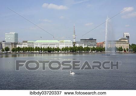 Stock Photo - "View over the Inner Alster Lake with Alster Fountain and an Alster swan towards the street of Neuer Jungfernstieg, Hotel Vier Jahreszeiten or Four Seasons Hotel and the television tower at the rear, Hamburg, Hamburg, Germany, Europe". Fotosearch