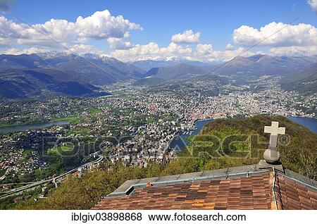 Stock Photo - "View over the roof of a chapel onto Lugano, Lake Lugano and the Alps, Monte San Salvatore mountain, Lugano, Canton of Ticino, Switzerland, Europe". Fotosearch